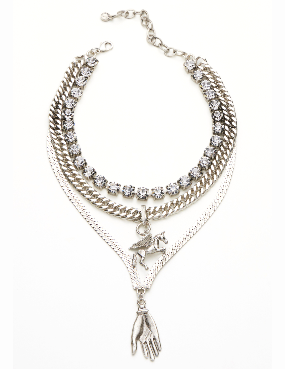 A triple layered necklace with a mix of metallic finishes and a charm in the shape of a bird.